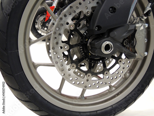 Brake disc and calipers on the front wheel of sport motorcycle stock photo