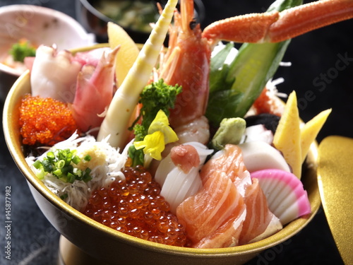 Bowl of fresh sushi with sashimi tuna, salmon, red eggs, crabs, squid and bamboo shoots