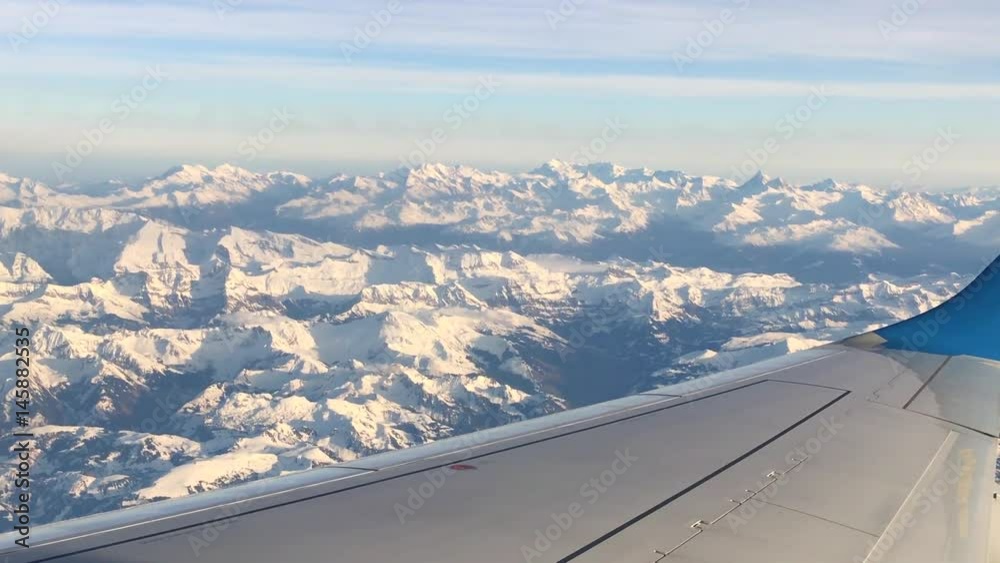  Point of view on snow mountains from airplane.