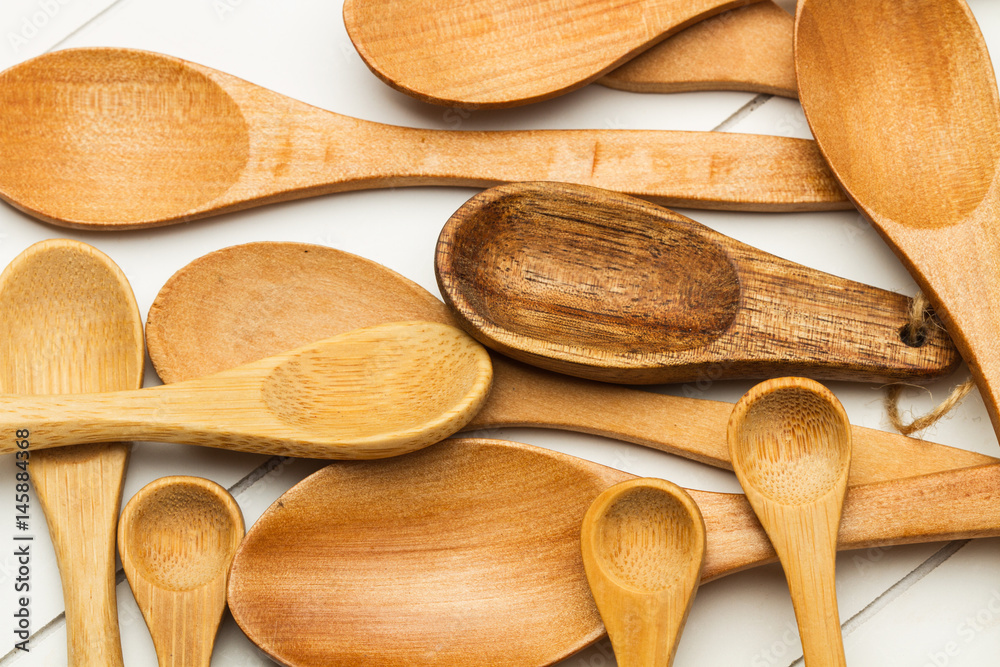 Cucharas de madera de diferentes tamaños variedad sobre tabla de madera blanca. Vista superior Cucharas de madera de diferentes tamaños variedad sobre tabla de madera blanca. Vista superior