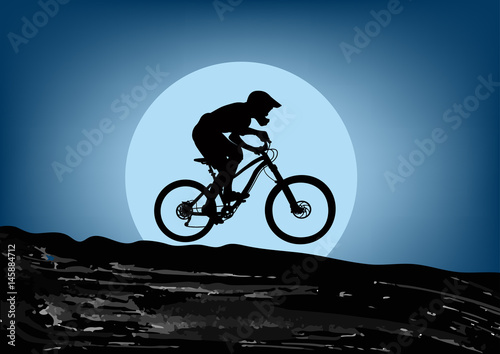 Silhouette of a cyclist riding a mountain bike