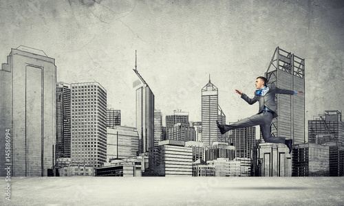 Businessman jumping high