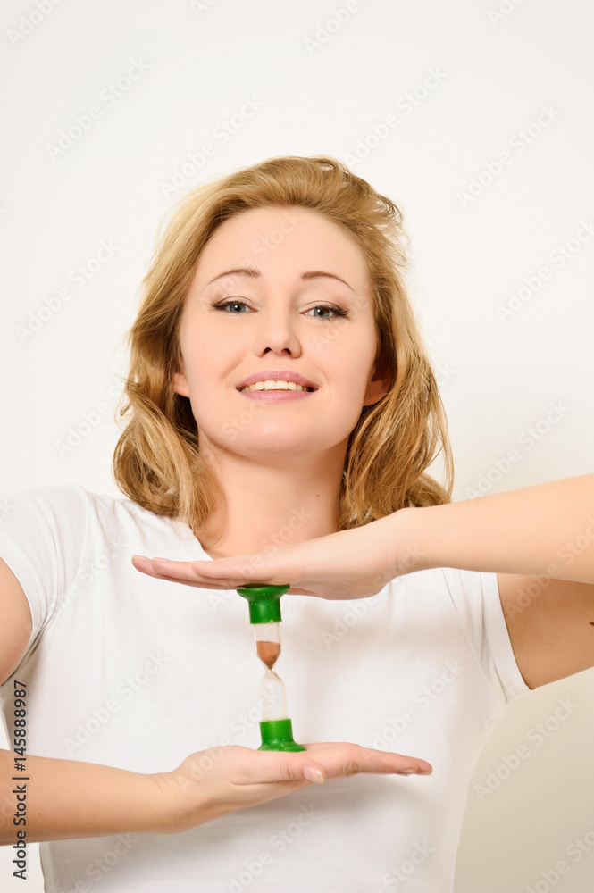 Young business woman with hourglass - time concept Young business woman with hourglass - time concept