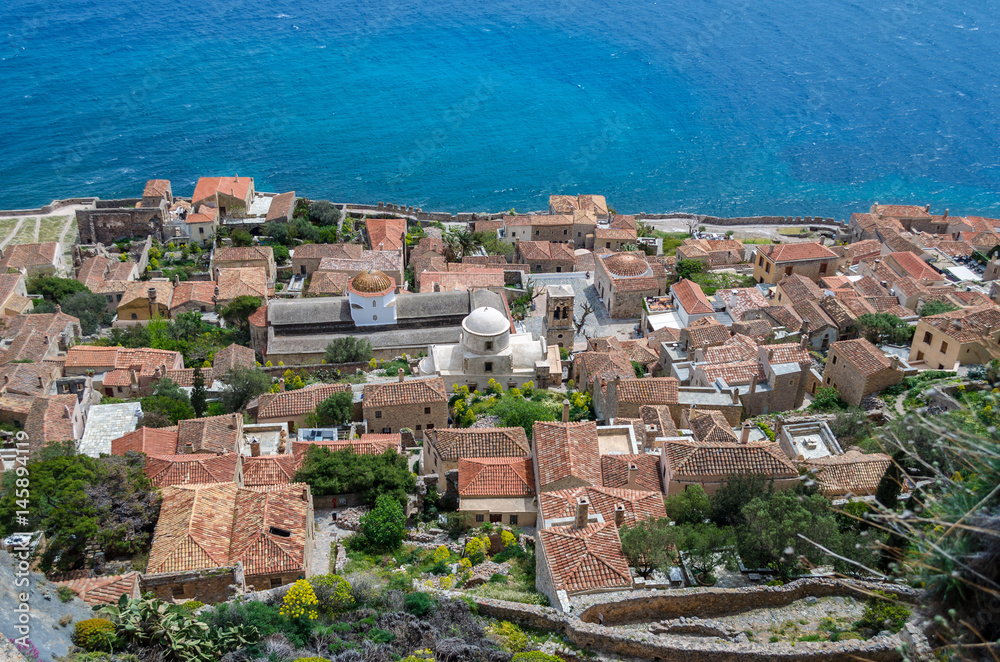 aerial view of the  medieval castle of monemvasia with the traditional stone houses, the Byzantine churches and  the crystal-clear water of the sea.