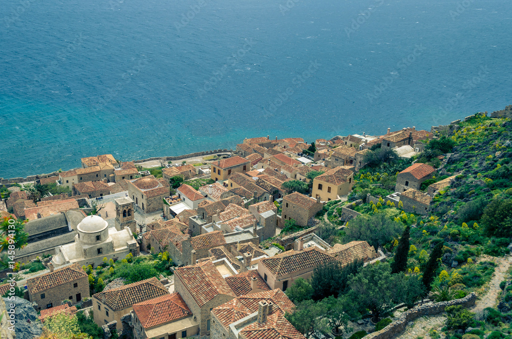 aerial view of the  medieval castle of monemvasia with the traditional stone houses, the Byzantine churches and  the crystal-clear water of the sea.