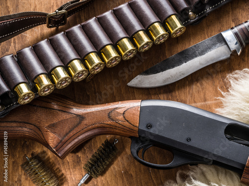 Pump action shotgun, 12 mm hunting cartridge  and hunting knife.
