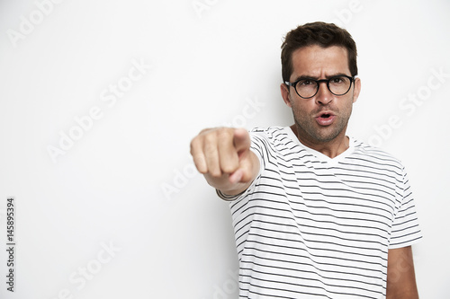 Guy angrily pointing at camera, portrait