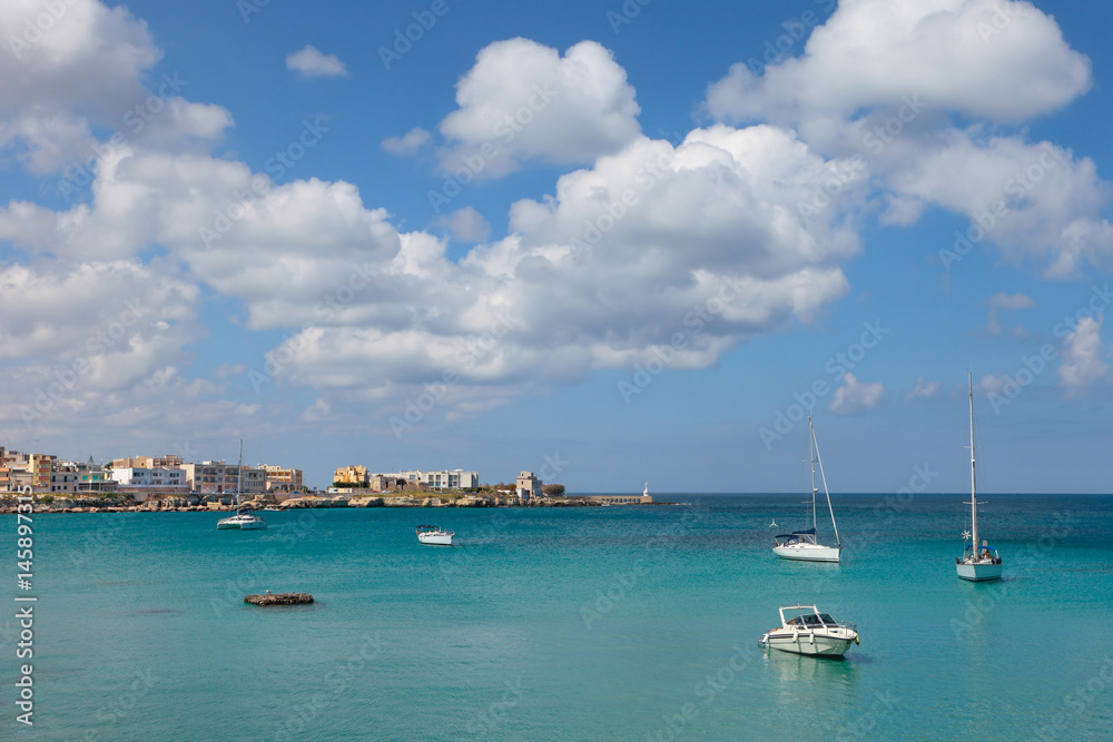 Clean blue sea of Otranto with yachts, Salento, Apulia, Italy