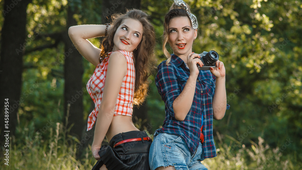 two girls are outdoors laughing two girls are outdoors laughing