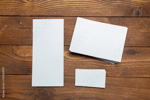 blank white business cards on wooden background.