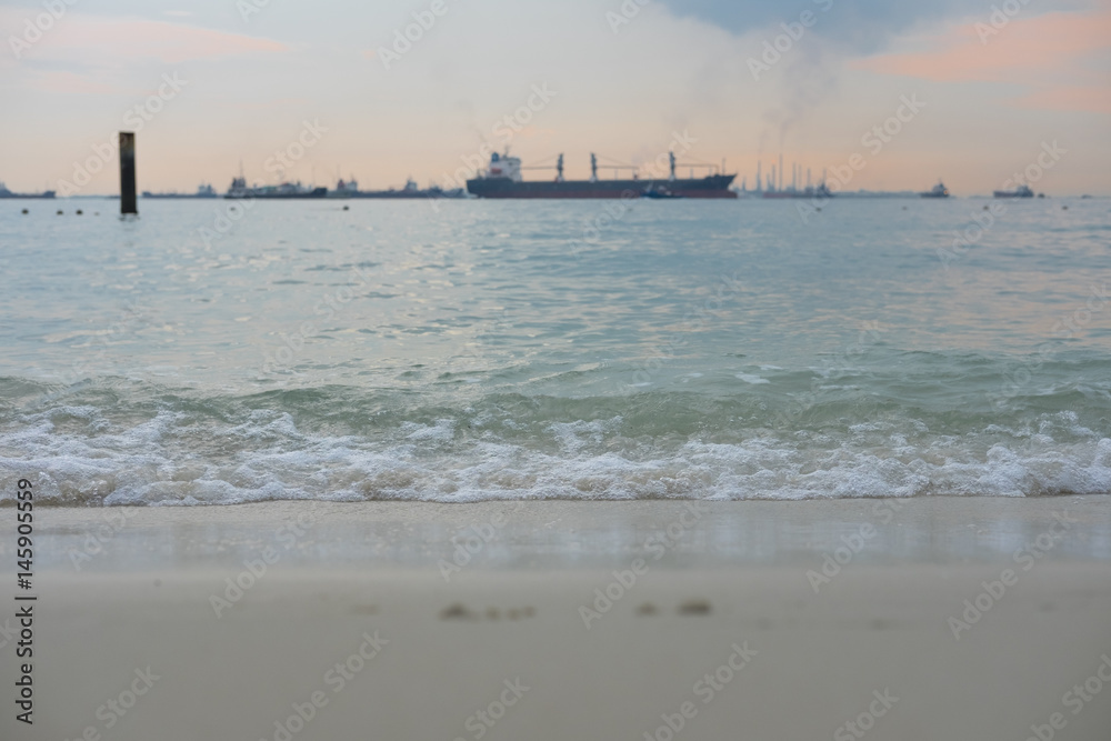 sea in twilight it so quiet have cargo ship and dock background,this image for landscape and nature