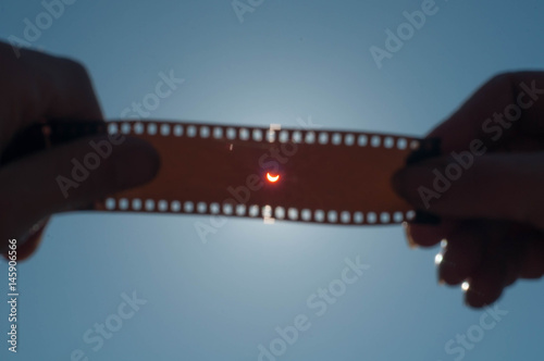 A solar Eclipse, the hand holding exposed film,