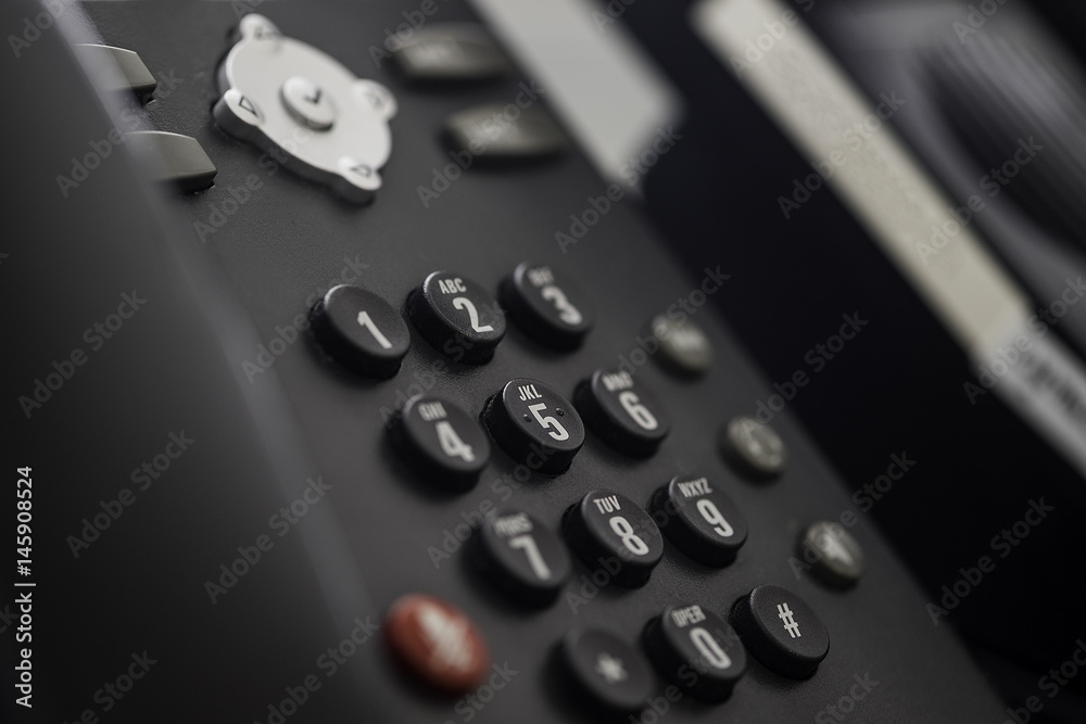 Set of black telephones on a desk, receiver close-up. Set of black telephones on a desk, receiver close-up.