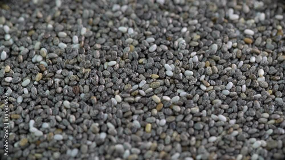 Black chia seeds background close-up rotating on a turntable Black chia seeds background close-up rotating on a turntable