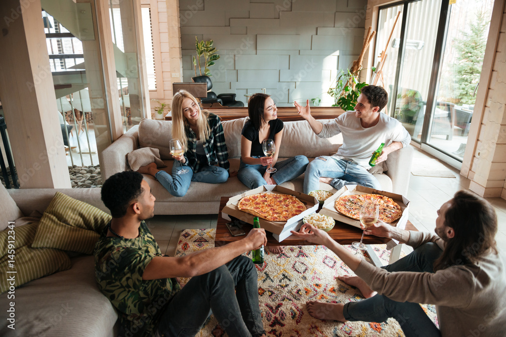 Group of young cheerful friends hanging out together at home - obrazy, fototapety, plakaty 