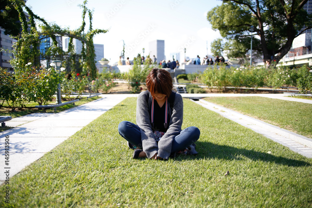 Japanese girl sitting on the lawn Japanese girl sitting on the lawn