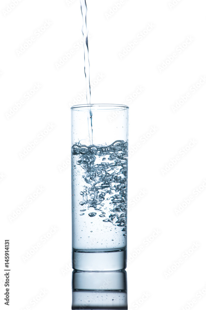 Drinking water is poured into a glass Drinking water is poured into a glass