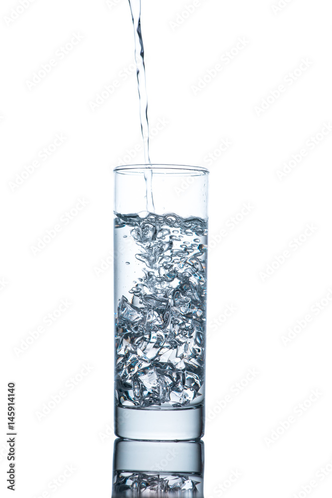 Drinking water is poured into a glass Drinking water is poured into a glass