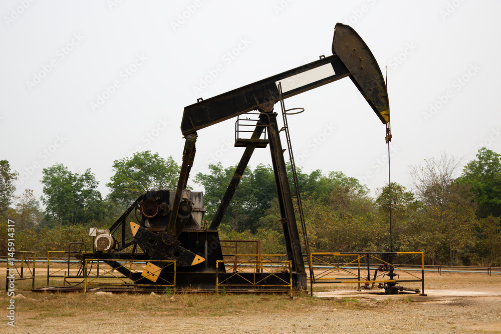 Pumpjack in an oil well in Tanjung, Kalimantan, Indonesia. Pumpjack in an oil well in Tanjung, Kalimantan, Indonesia.