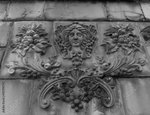 Goddess of fertility bas-relief on a fence photo