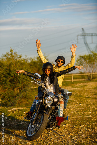Fototapeta Naklejka Na Ścianę i Meble -  Beautiful young couple with a classic motorcycle