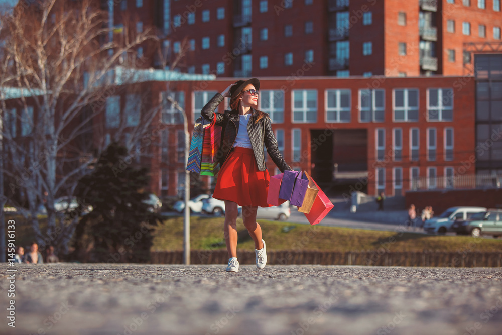 The girl walking with shopping on city streets