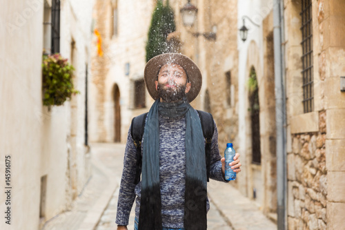 Man spraying water with mouth photo