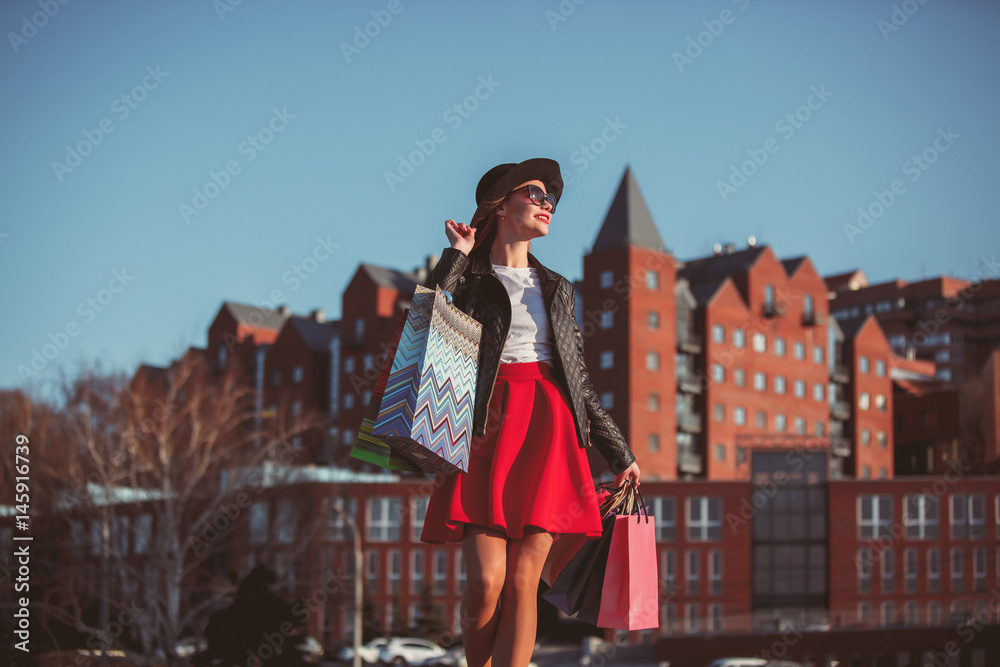 The girl walking with shopping on city streets