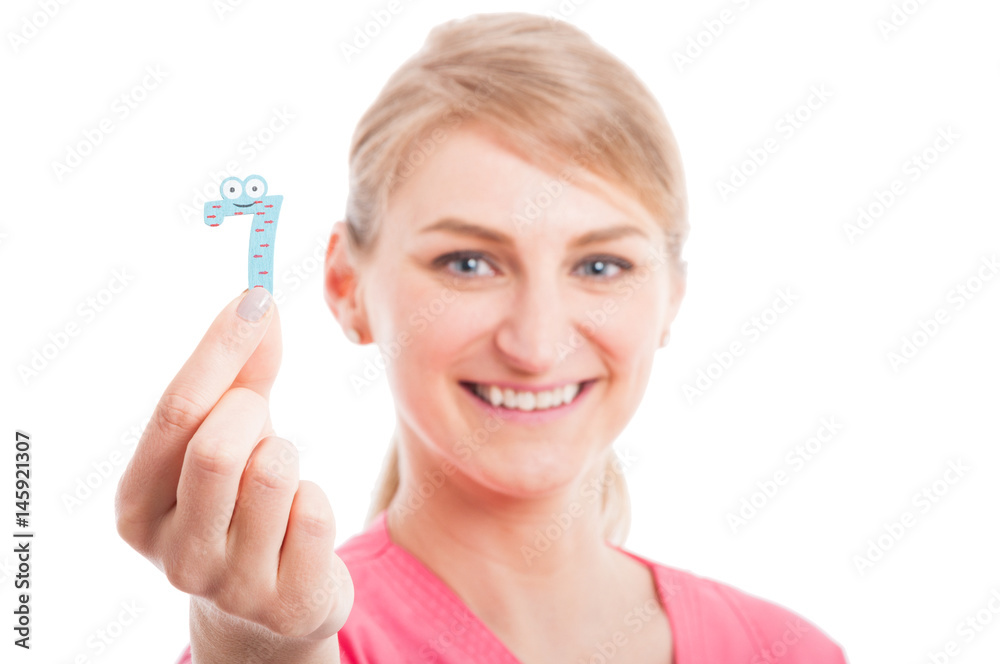 Selective focus close-up of pediatrician female showing number seven Selective focus close-up of pediatrician female showing number seven