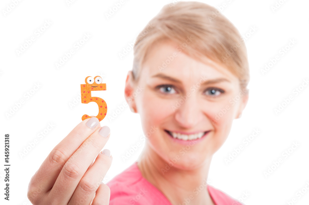 Selective focus close-up of pediatrician lady showing number five Selective focus close-up of pediatrician lady showing number five