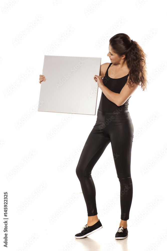 young beautiful brunette holding a blank board for advertisement young beautiful brunette holding a blank board for advertisement