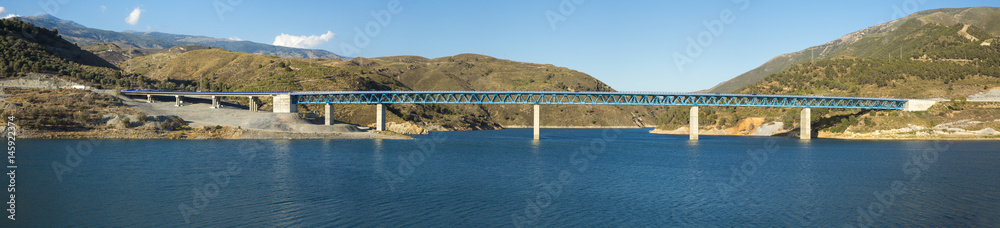 Panoramic of a bridge over a dam.
