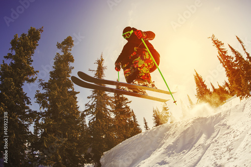 The skier jumps from a springboard in the ski resort. photo