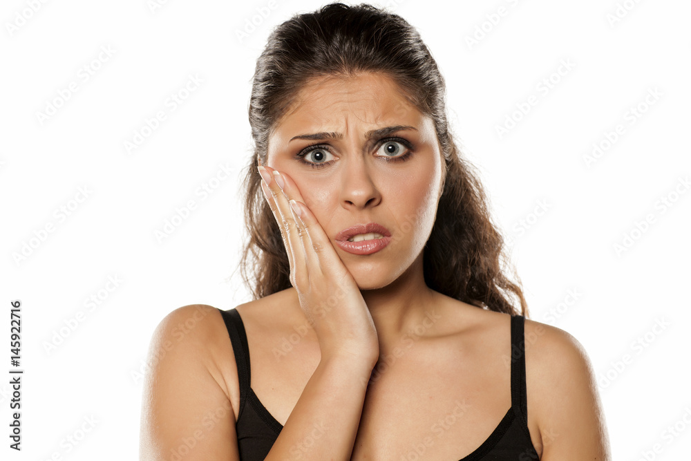 The young brunette has a toothache The young brunette has a toothache