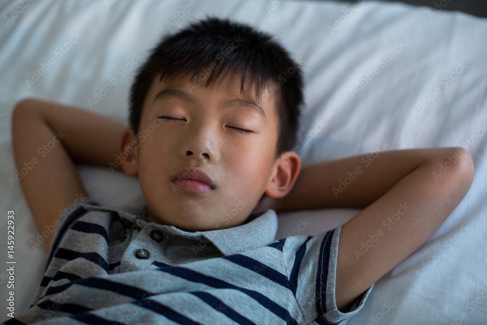 Boy sleeping on bed in bedroom Boy sleeping on bed in bedroom