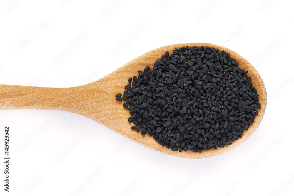 Black cumin seed (Nigella sativa) in wooden spoon isolated on white background. Top view Black cumin seed (Nigella sativa) in wooden spoon isolated on white background. Top view