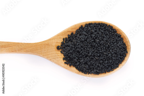 Black cumin seed (Nigella sativa) in wooden spoon isolated on white background. Top view