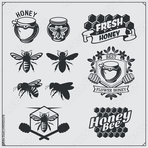 Set of honey labels, badges and design elements. Honeycombs, bee silhouettes, honey emblems.