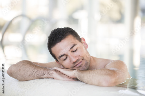 Beautiful brown man relaxing in thalassotherapy thermal water