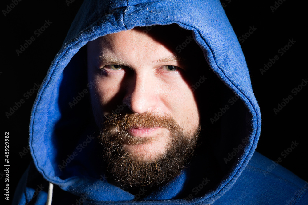 Solid bearded middle-aged man in a hood portrait Solid bearded middle-aged man in a hood portrait