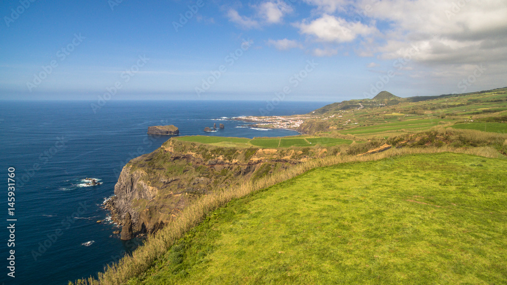 Green fields of Azores with atlantic ocean on background