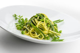 Pasta dish spaghetti with herbs and spring veggies