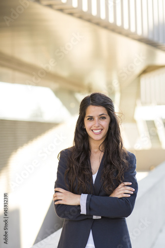 Portrait of a bussines woman. She is wearing a black suit.