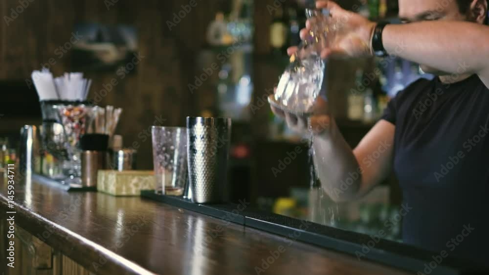 The barman is preparing a cocktail in the night club bar 4k The barman is preparing a cocktail in the night club bar 4k