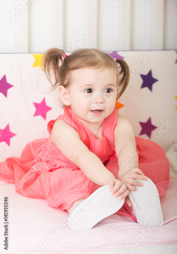 Cuteness.Happy little girl at studio with pink princesse dress