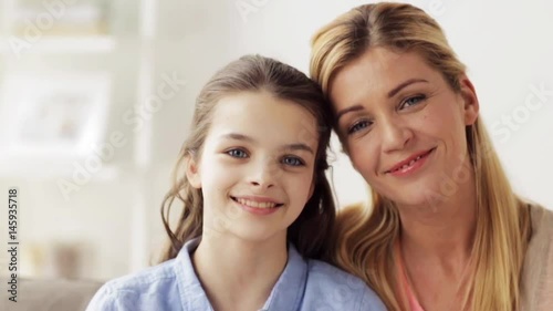 happy smiling mother and girl at home