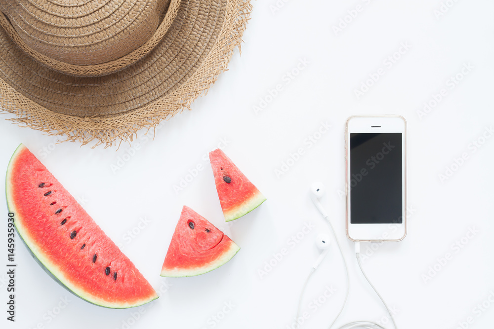 Fresh watermelon with smartphone and hat, Summer concept flat lay on white background Fresh watermelon with smartphone and hat, Summer concept flat lay on white background
