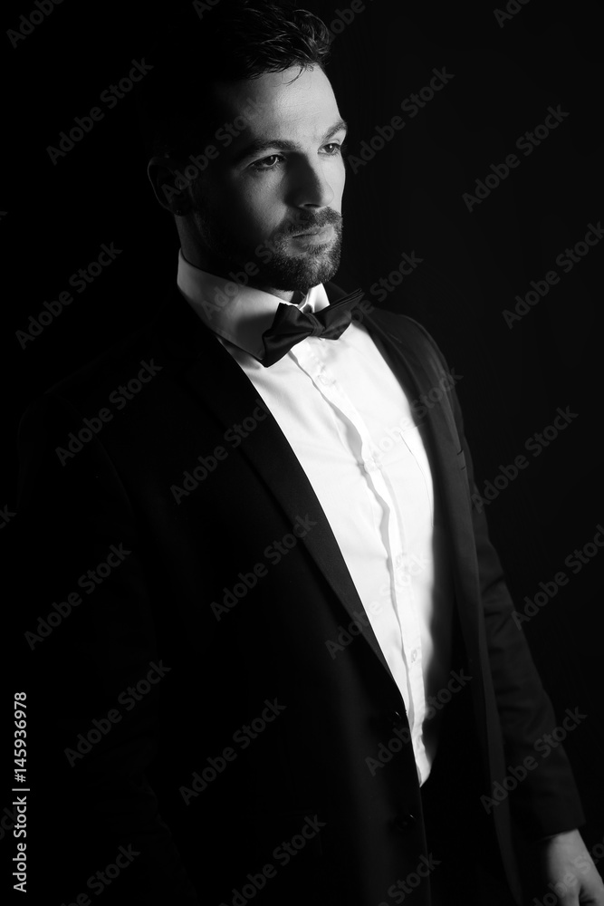 Black and white photography of a man wearing a tuxedo Black and white photography of a man wearing a tuxedo