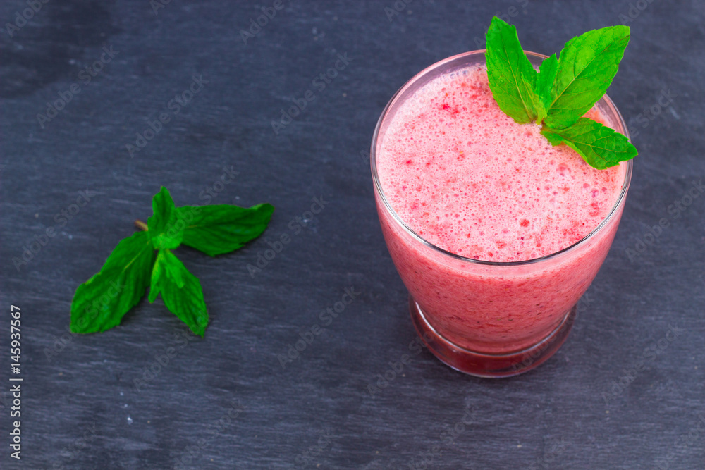 A cup of Strawberry Juice with mint leaves on an Oriental Colorful Background / Cup of Strawberry Juice on an Oriental Colorful Background with Flowers & mint leaves A cup of Strawberry Juice with mint leaves on an Oriental Colorful Background / Cup of Strawberry Juice on an Oriental Colorful Background with Flowers & mint leaves