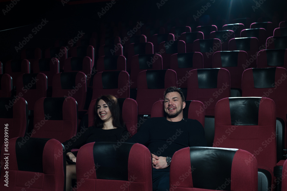 Young caucasian couple watching movie in theater Young caucasian couple watching movie in theater